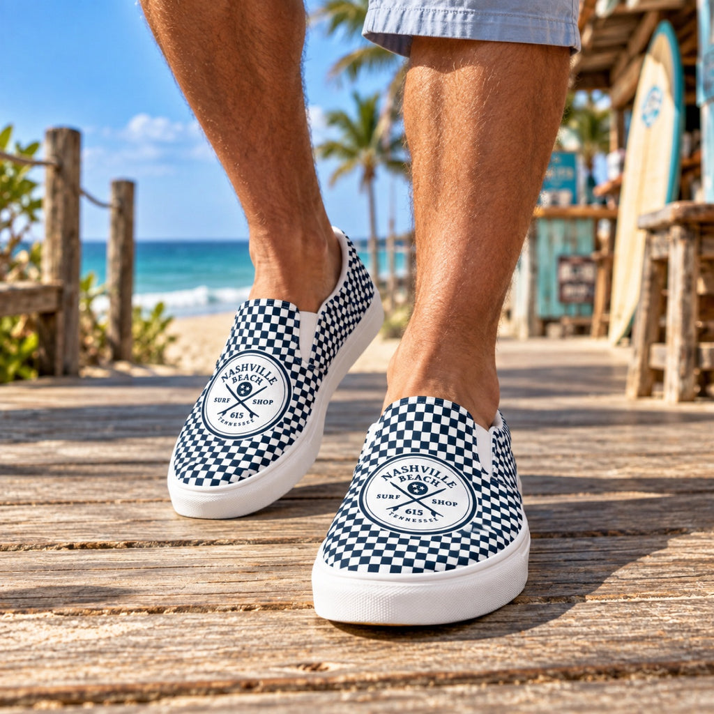 NB Trucks Checkerboard Slip-Ons worn on a beach boardwalk